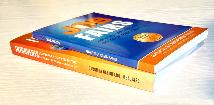 Two books titled 'Introverts & Job Search' and 'Job Fairs' by Gabriela Casineanu on a light wooden surface.