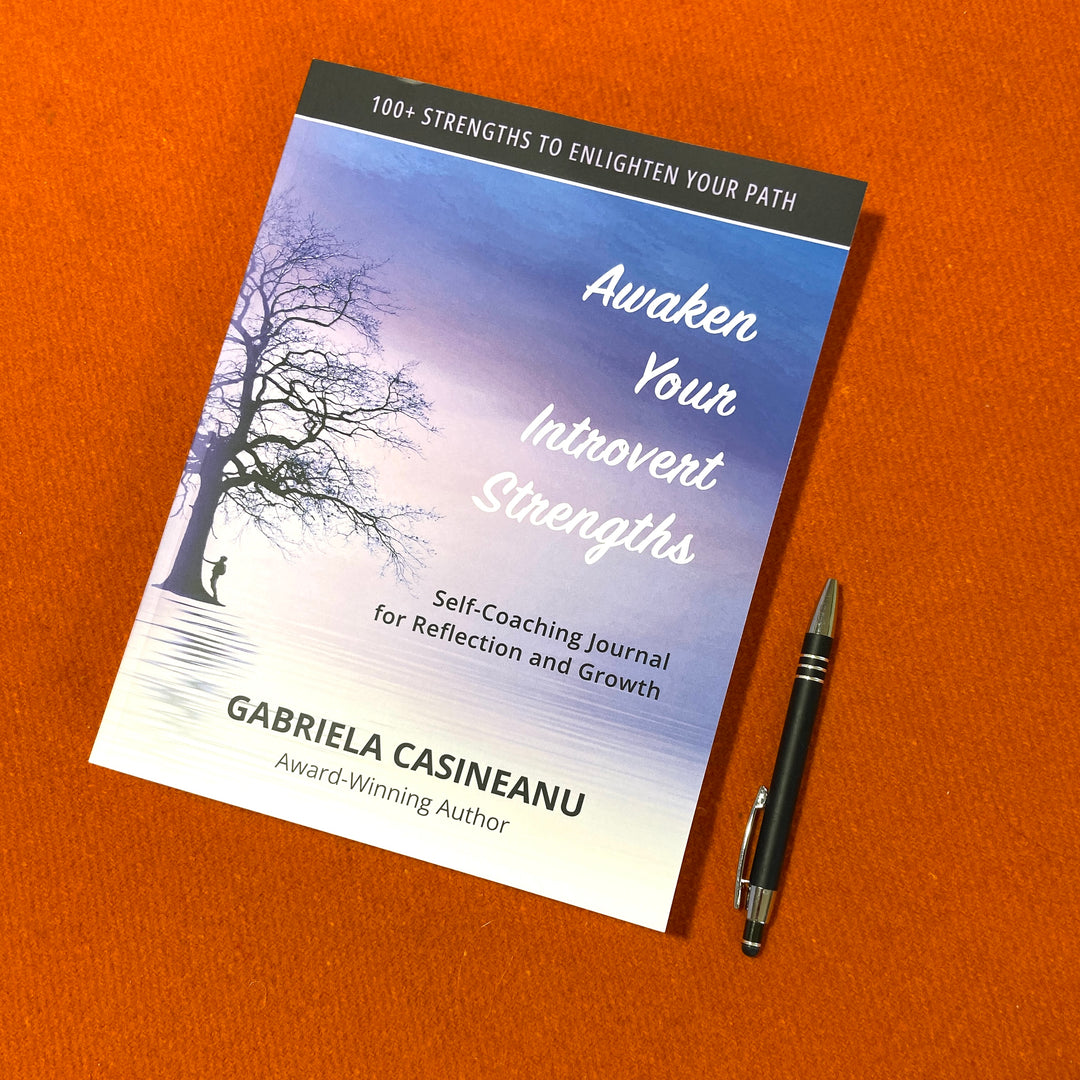 Journal titled 'Awaken Your Introvert Strengths' by Gabriela Casineanu on an orange background with a pen beside it.