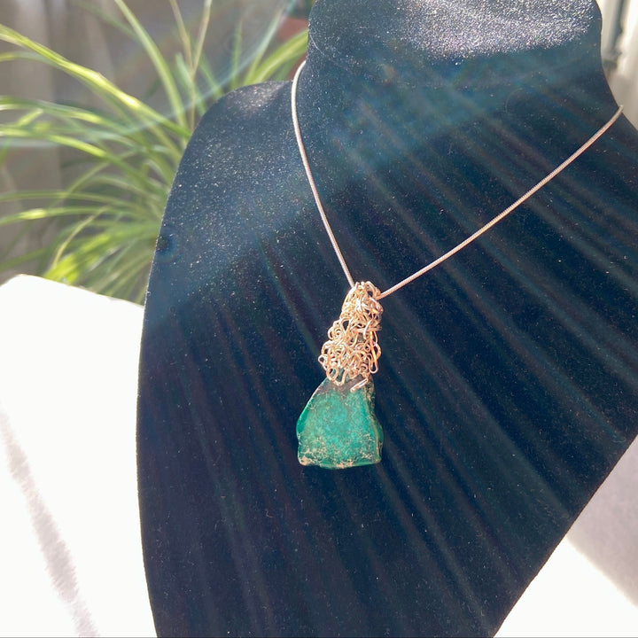 Green Jasper stone pendant on a black display