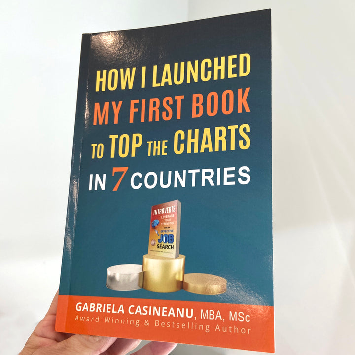 Image with a hand holding the book How I Launched My First Book to Top the Charts in 7 Countries