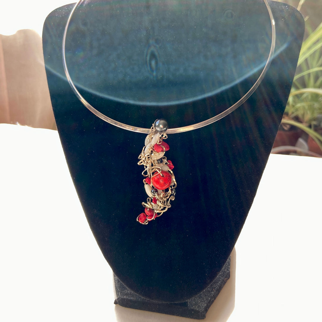 Necklace Pendant with red Jasper stones and black beads on a black stand