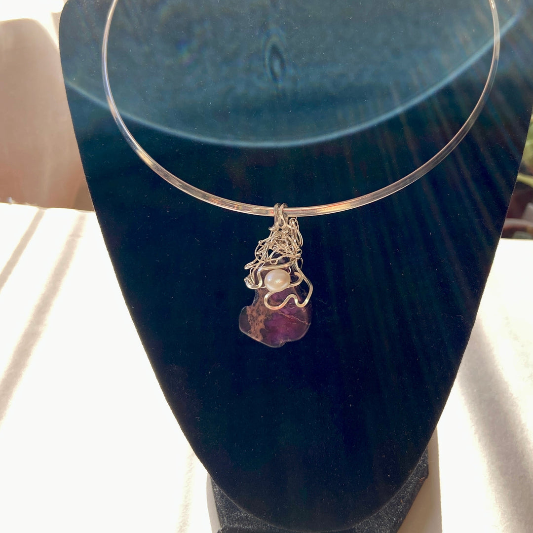 Purple Jasper stone pendant with pearl on an a black display