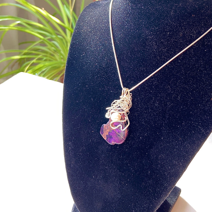 Purple Jasper stone pendant with pearl on an a black display