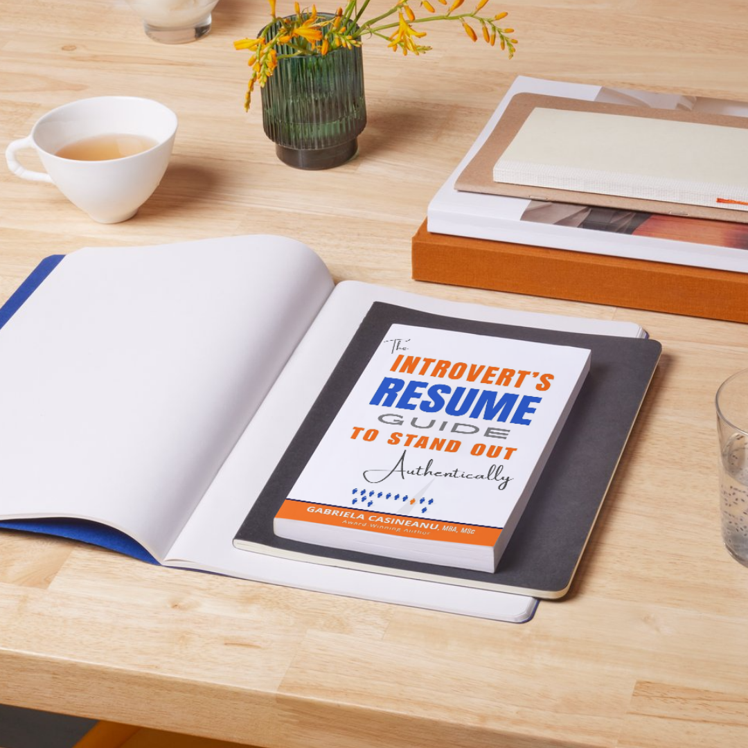 An open notebook or book on a light wood desk with a copy of &