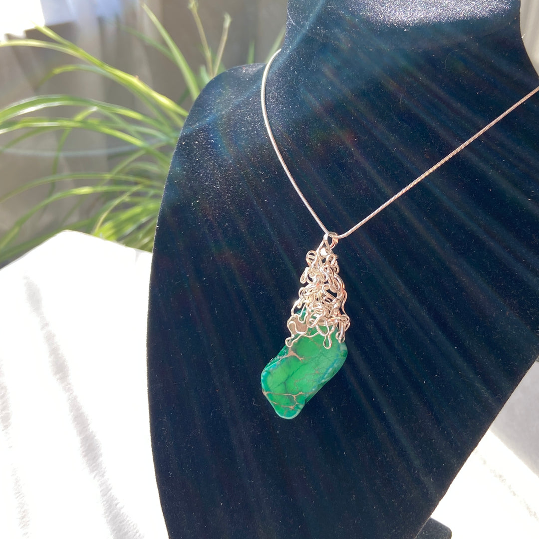  green Jasper gemstone pendant, wire-wrapped,  on black display