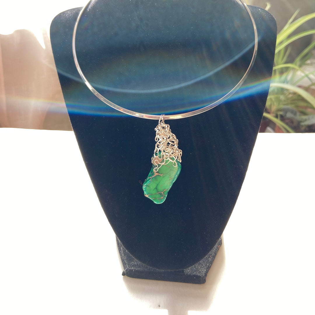  green Jasper gemstone pendant, wire-wrapped,  on aa black display