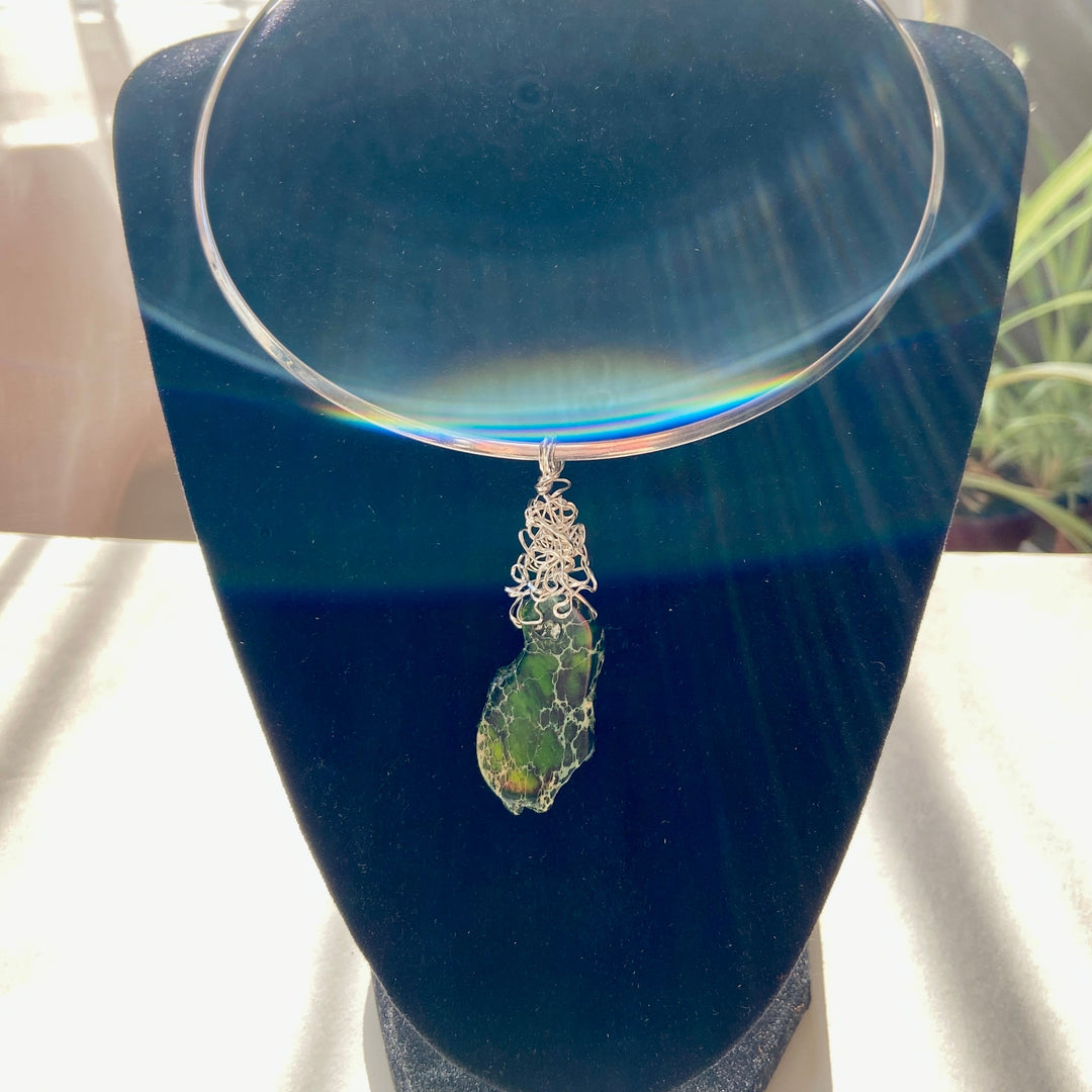 Necklace with a green Jasper stone pendant on a stand