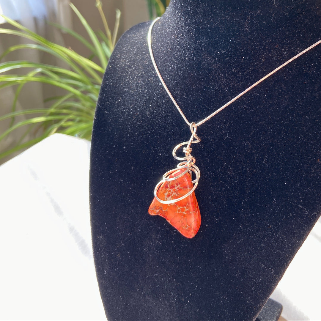Necklace with a orange Jasper stone pendant silver-plated spiral on a black velvet stand