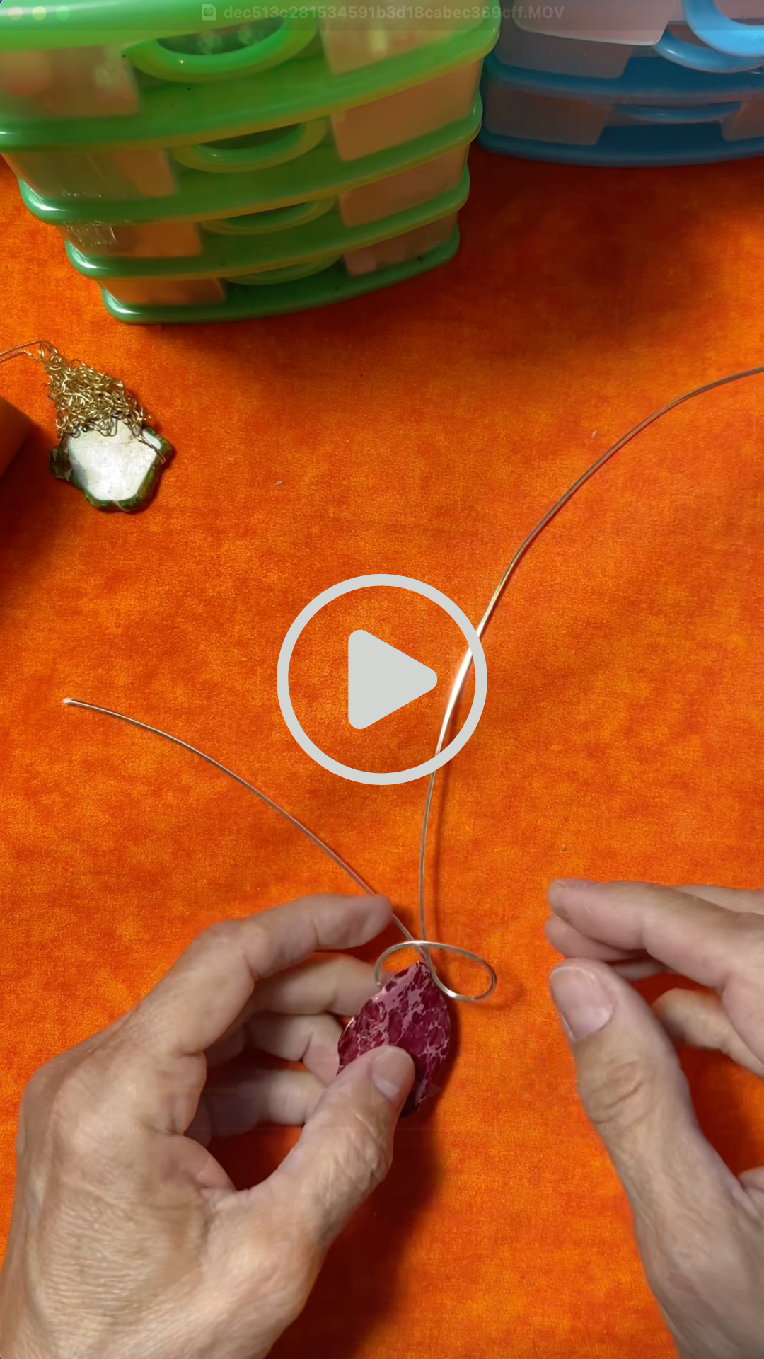 Artist Gabriela Casineanu hand-wrapping a unique stone pendant