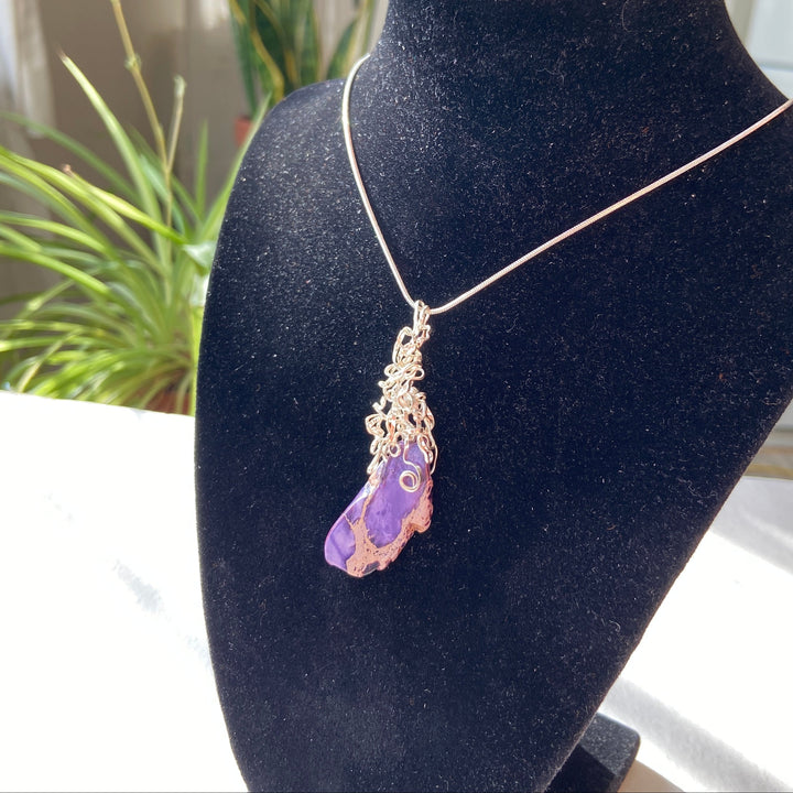 Necklace with a purple Jasper stone pendant on a black display